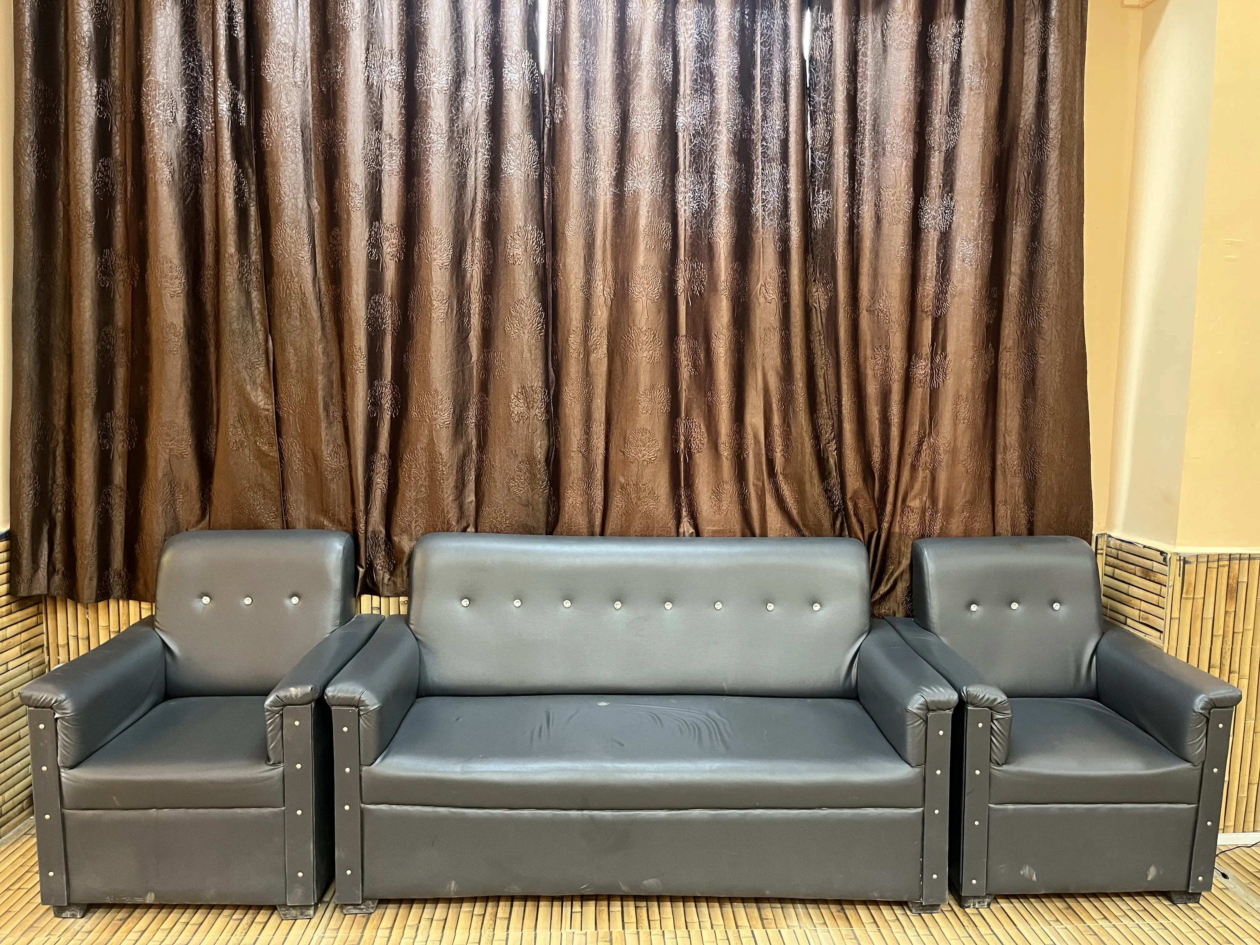 Professional hairstyling service with client seated on a luxurious salon sofa
